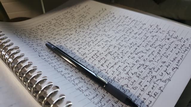A notebook with a pen